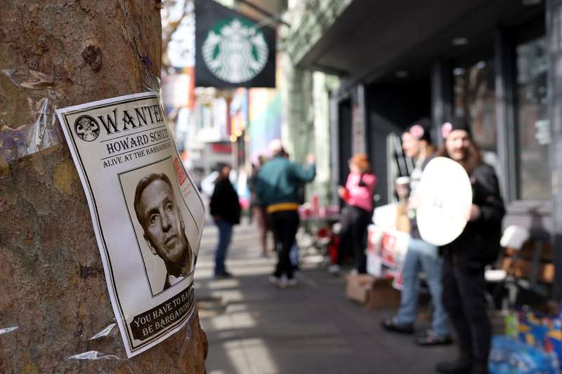 A photo of Starbucks interim CEO Howard Schultz is posted on a tree as striking Starbucks workers picket outside of a Starbucks coffee shop during a national strike on November 17, 2022, in San Francisco, California.
