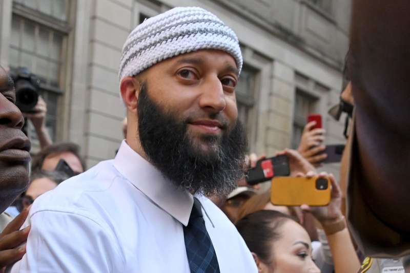 Adnan Syed surrounded by cameras. 